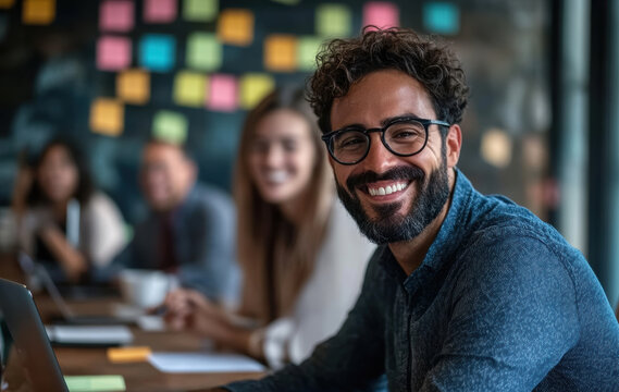 a cheerful person in a collaborative, colorful setting with the team suits campaigns on innovation and teamwork.