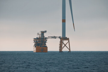 Offshore Service Support Vessel With Walk-To-Work System Engaged In Personnel Transfer To The Wind...