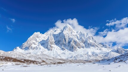 Snow-capped mountain range under blue sky, winter landscape, potential travel poster