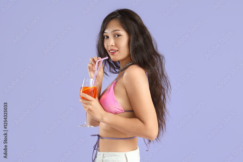 Wall mural Young Asian woman with aperol spritz cocktail on lilac background