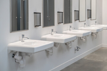 interior of public restroom with sinks in a row