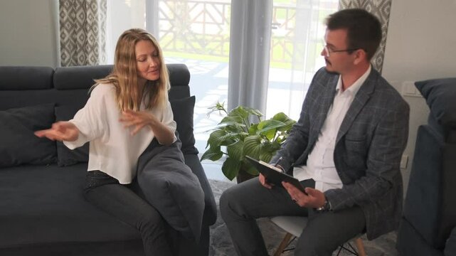 The psychotherapist listens attentively, observing the patient reflecting aloud and sharing thoughts and feelings. Analyzing her emotions, doctor guides her toward constructive progress in therapy.