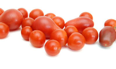 Mini black, red, and yellow tomatoes isolated on white