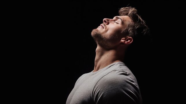 Dramatic portrait of man looking up. Great for emotional expression, artistic portraiture, and personal strength.