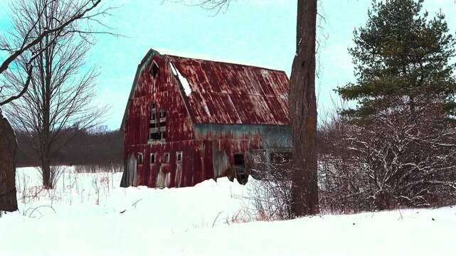 An old, weathered barn in a farm field