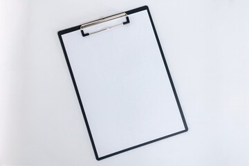 Clipboard with blank white paper on white background