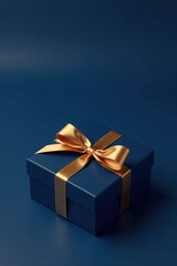 Obraz premium A luxuriously wrapped navy blue present box adorned with a radiant gold ribbon, a symbol of elegance and festive celebration.