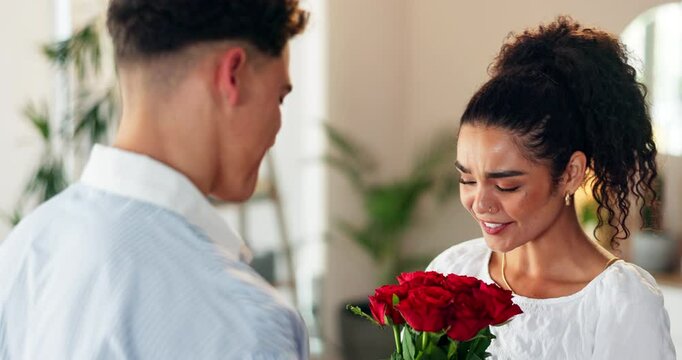 Flowers, romance or surprise with couple in home together for anniversary or valentines day. Hug, smile and thank you with man giving bouquet to woman in apartment for celebration, gift or love - Powered by Adobe