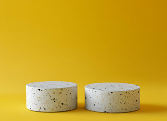 Two terrazzo podiums showcased against a vibrant golden backdrop, ideal for minimalist product presentation, emphasizing texture and clean lines