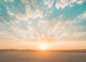 Obraz premium Serene desert landscape with a radiant sunrise, soft pastel colors blending across sand dunes and a cloud-strewn sky, creating a peaceful vista