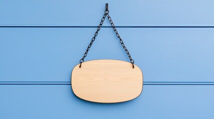 Blank wooden sign hanging on a blue wall, ideal for customizable messages or branding