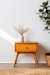 Modern minimalist interior featuring a wooden nightstand with a vase and dried flowers, soft lighting