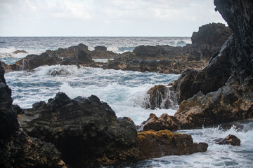 Rocky sea coast. Beautiful turquoise waters of the Sea. Ocean waves against the coastal rocks. Scenery view on ocean. Wonderful summer seascape.