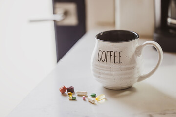 A Coffee Mug with a Morning Round of Medication and Vitamin Doses to Start the Day. 