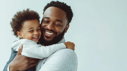 Obraz premium A man is holding a baby and both of them are smiling