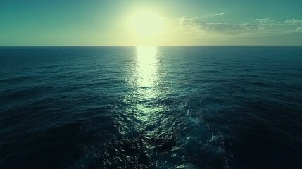 Ocean sunset aerial view; calm waves, sun's reflection, travel background