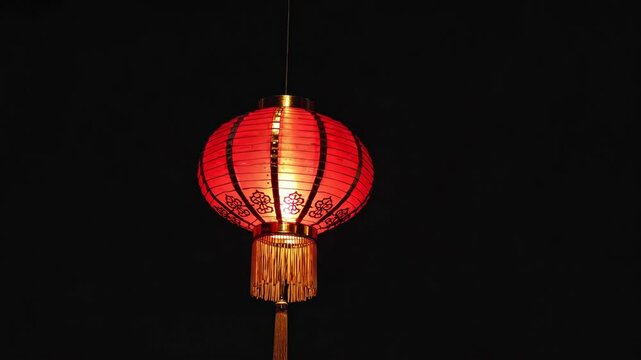 red chinese lantern with ornate patterns against a dark background. cultural symbolism and festive decoration concept