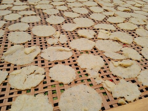 Raw rice crackers or kerupuk gendar or lempeng are dried in the hot sun. Traditional crackers from Indonesia