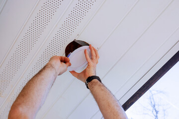 Contractor installs new led lamp at ceiling renovated home improvement.