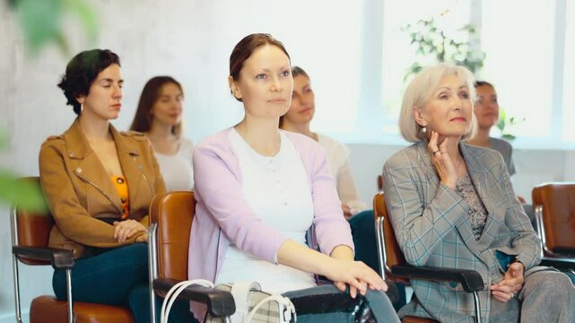 in lecture hall, small group of female students attentively listens to teacher s speech. Advanced training, optional discipline