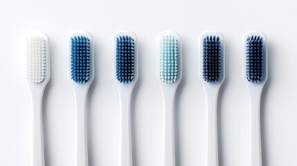 collection of six toothbrushes with varying bristle colors and designs, showcasing dental hygiene tools for effective cleaning