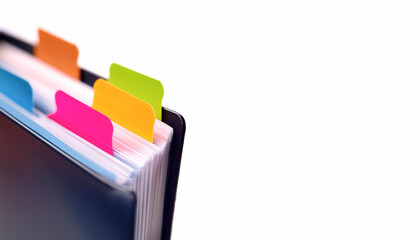 close-up of a dark-blue binder with -coded index tabs