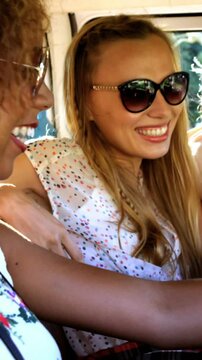 Hipster playing the guitar in a van