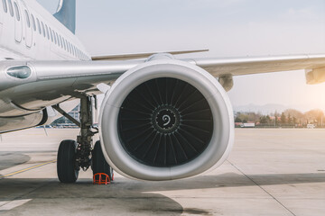 Close-Up View of Aircraft Engine on the Tarmac at Sunset