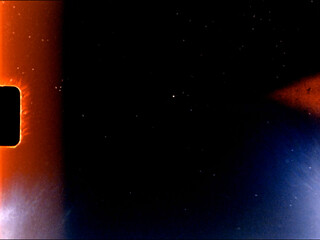 Super 8 film burning with orange and blue light leaks and particles