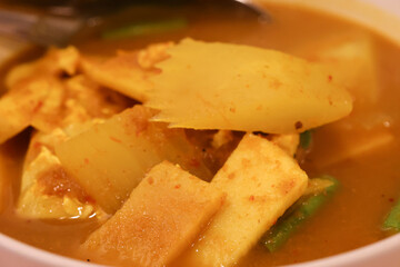 Savory dish with sliced ingredients in a rich broth.