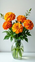 Marigold flowers blooming in a vase with fresh greens and branches, orange marigold blooms, arrangement, flowers in vase