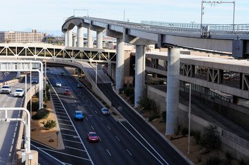 The elevated PHX Sky Train guideway spans over roadways at Phoenix Sky Harbor International Airport, integrating automated passenger transit with highway infrastructure for seamless connectivity
