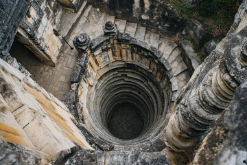 Naklejka premium A circuitous staircase spiraling within an ancient temple, culminating in a rooftop flag that marks the ultimate prize for the determined