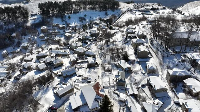 Aerial view of the town of Nymfaio in harsh winter with lots of snow on the rooftops. Florina, Greece.