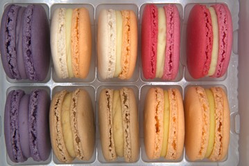 Sweet colorful of French macarons cake in isolated plastic tray.