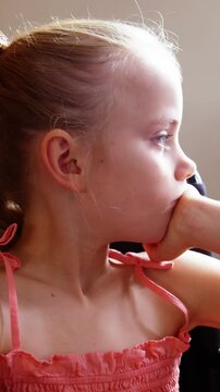 Disabled school girl looking through window in classroom