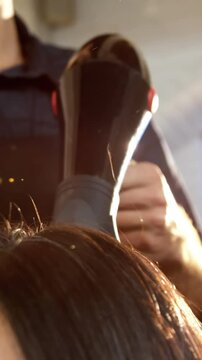 Woman getting his hair dried with hair dryer