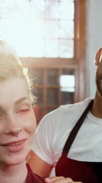 Male hairdresser styling a womans hair