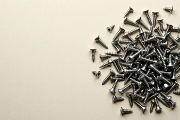 A Pile of Metallic Fasteners on a Pale Background, Ready for Construction or Repair Projects