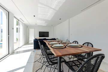 a close up image of a wooden dining table in luxury mediterranean holiday home for sale 