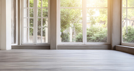 Bright and airy indoor space with large windows and wooden flooring