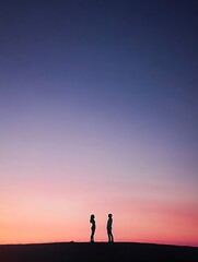 Fototapeta premium Silhouette of a couple standing on a cliff
