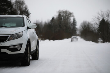 Winter Drive: Snow-Covered Road with Parked SUV and Bare Trees in the Background