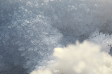 Close-up of Delicate Snow Crystals Forming Intricate Patterns on a Bright Winter Day