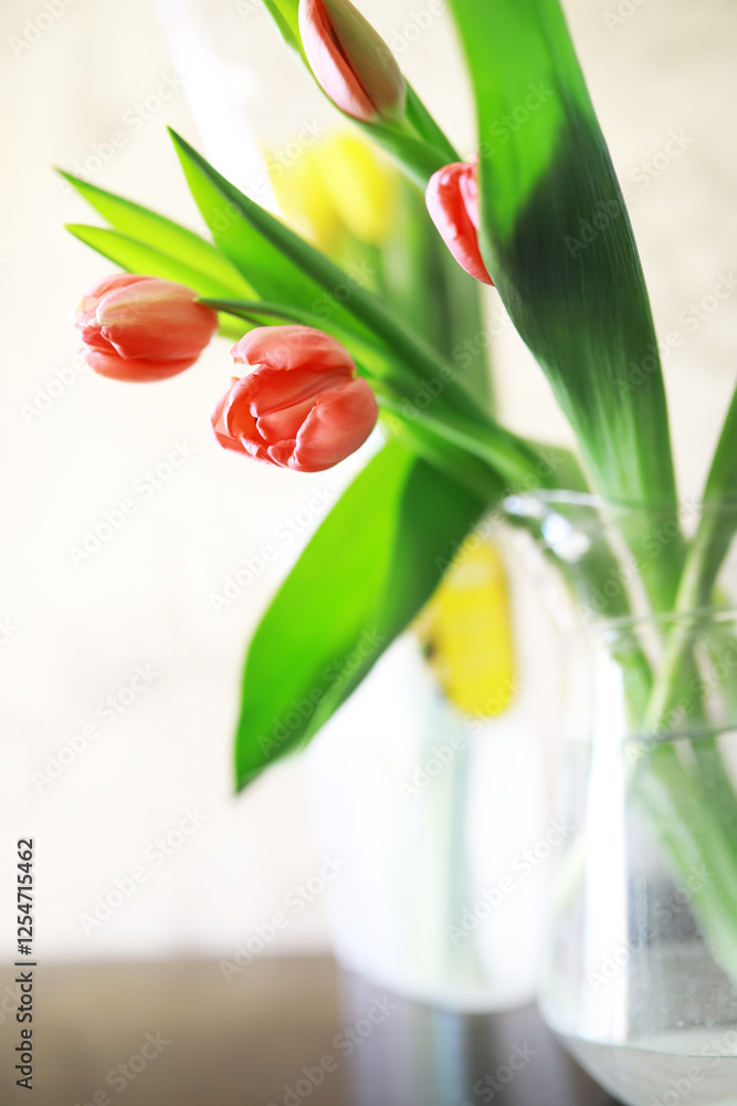 Poster Fresh Red and Yellow Tulips in Glass Vase with Soft Light Background