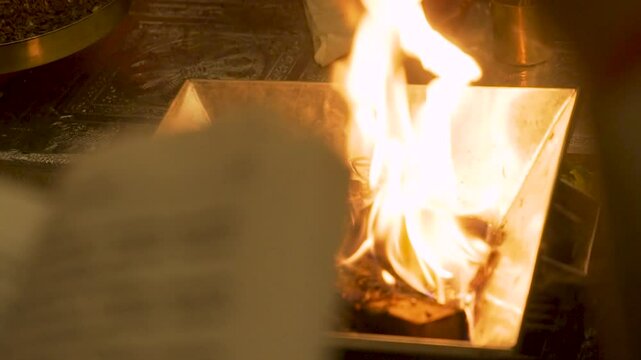 Religious book with firelight during Hindu worship