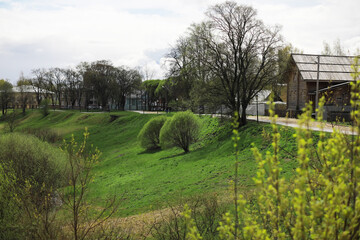 Spring Countryside Landscape with Green Fields and Rustic Barns