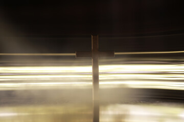 Silhouette of Wooden Cross Surrounded by Mystical Light and Fog
