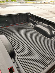 Close-Up of an Empty Pickup Truck Bed with a Textured Liner, Showcasing Cargo Space and Durability for Heavy-Duty Transport