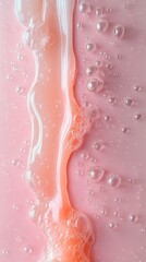 Fototapeta premium Pink liquid with bubbles flowing down on a solid pink background abstract cosmetic texture